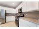 Stylish kitchen featuring white cabinets and stainless steel appliances at 4963 Pensier St, Las Vegas, NV 89135