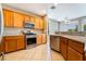 The kitchen features stainless steel appliances, granite countertops, and a view to the backyard at 4963 Pensier St, Las Vegas, NV 89135