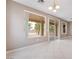 Bright living room area showcasing windows, neutral walls and tile floors at 4963 Pensier St, Las Vegas, NV 89135