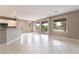 Bright open-concept living room with tile flooring, neutral paint, and sliding glass doors to the backyard at 4963 Pensier St, Las Vegas, NV 89135