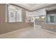 Unfurnished living space with tile floors, neutral walls, and an open view into the kitchen and entry at 4963 Pensier St, Las Vegas, NV 89135