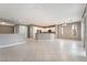 Open-concept living space with tile floors, neutral walls, and a kitchen with white cabinetry at 4963 Pensier St, Las Vegas, NV 89135