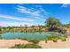 Scenic pond on the golf course with a small waterfall, enhancing the natural beauty of the community at 4963 Pensier St, Las Vegas, NV 89135