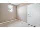 Neutral room with tiled floors, a window, and white door at 4963 Pensier St, Las Vegas, NV 89135