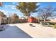 Expansive backyard with concrete patio, shed, and mature shade trees at 4970 E Van Buren Ave, Las Vegas, NV 89110