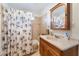 Full bathroom featuring tile surround, vanity, and shower-tub combo at 4970 E Van Buren Ave, Las Vegas, NV 89110