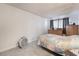 Bedroom with cozy carpet, dresser, side table, and window for natural light and comfortable living at 4970 E Van Buren Ave, Las Vegas, NV 89110