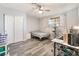 Cozy bedroom featuring wood-look flooring, ceiling fan and closet at 4970 E Van Buren Ave, Las Vegas, NV 89110