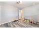 Bedroom with plank floors, light paint and view to another room at 4970 E Van Buren Ave, Las Vegas, NV 89110
