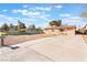 Inviting single-story home with a lengthy driveway and a secure chain-link fence, complemented by desert landscaping at 4970 E Van Buren Ave, Las Vegas, NV 89110