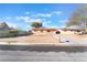 Charming single-story home featuring a desert landscape, driveway, and secure chain-link fence at 4970 E Van Buren Ave, Las Vegas, NV 89110