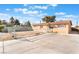 Charming home with a long driveway, chain-link fence, and desert landscaping, offering potential and privacy at 4970 E Van Buren Ave, Las Vegas, NV 89110