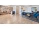 Spacious living room featuring tile floors, a decorative stone fireplace, and a smooth transition into the dining area at 4970 E Van Buren Ave, Las Vegas, NV 89110
