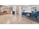 Comfortable living room features a stone fireplace and seamless flow into the kitchen and dining area at 4970 E Van Buren Ave, Las Vegas, NV 89110