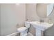 Powder room featuring a pedestal sink and a sleek round mirror at 524 Teovani St # 826, Henderson, NV 89052