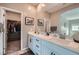 This bathroom features double sinks, a large mirror, and a walk-in closet at 524 Teovani St # 826, Henderson, NV 89052