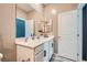 Modern bathroom featuring a spacious vanity with double sinks and a well-lit mirror with a storage cabinet at 524 Teovani St # 826, Henderson, NV 89052