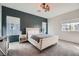 Stylish bedroom with a gray accent wall, a cozy queen bed, and ample natural light at 524 Teovani St # 826, Henderson, NV 89052