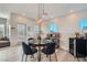 Dining room with a modern light fixture, seating for four, and a wine refrigerator at 524 Teovani St # 826, Henderson, NV 89052