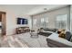 Bright living room boasts modern decor, a stylish sectional, and a large television at 524 Teovani St # 826, Henderson, NV 89052