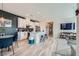 Open-concept living space featuring modern kitchen with island, dining area, and living room with TV at 524 Teovani St # 826, Henderson, NV 89052