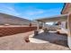 Landscaped backyard featuring a covered patio, seating area, and above ground pool at 531 Coolidge Ave, Henderson, NV 89015