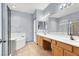 Bathroom with a large vanity, bathtub, and neutral color scheme at 531 Coolidge Ave, Henderson, NV 89015