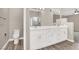 Bright bathroom features a double vanity with white cabinets, marble countertops and glass enclosed shower at 531 Coolidge Ave, Henderson, NV 89015
