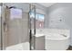 Modern bathroom featuring a separate shower and a luxurious soaking tub with natural light at 531 Coolidge Ave, Henderson, NV 89015