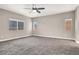 Large bedroom features soft carpeting, a ceiling fan, and multiple windows for ample lighting at 531 Coolidge Ave, Henderson, NV 89015