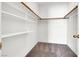 Walk-in closet with carpeted floors, rod for hanging clothes and white shelving at 531 Coolidge Ave, Henderson, NV 89015