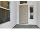 Welcoming front door with sidelight windows, providing natural light to the entryway at 531 Coolidge Ave, Henderson, NV 89015