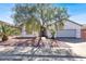Charming single-story home with desert landscaping, mature tree, and a two-car garage enhancing curb appeal at 531 Coolidge Ave, Henderson, NV 89015