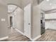 Hallway showcasing wood-look floors and access to the kitchen with stainless steel refrigerator and white cabinets at 531 Coolidge Ave, Henderson, NV 89015