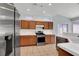 Well-lit kitchen features stainless steel appliances, tile flooring, ample counter space, and wood cabinets at 531 Coolidge Ave, Henderson, NV 89015