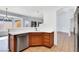 Functional kitchen area featuring wood cabinets, stainless steel dishwasher, tile flooring, and open layout at 531 Coolidge Ave, Henderson, NV 89015