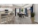 Updated kitchen with white cabinets, a center island, and dining area with backyard views at 531 Coolidge Ave, Henderson, NV 89015