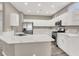 Modern kitchen with stainless steel appliances, white cabinets, and a large island with a marble countertop at 531 Coolidge Ave, Henderson, NV 89015