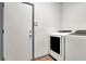 Laundry room with white washer and dryer, gray door, and tile floors at 531 Coolidge Ave, Henderson, NV 89015