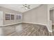 Spacious living room with wood-look floors, a ceiling fan, and backyard views at 531 Coolidge Ave, Henderson, NV 89015