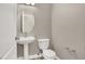 Powder room showcasing pedestal sink with round mirror, toilet, and light fixture at 531 Coolidge Ave, Henderson, NV 89015