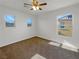 Bedroom featuring three windows and a ceiling fan with lights at 5638 Breckenridge St, North Las Vegas, NV 89081