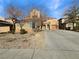 Charming two-story home featuring desert landscaping, a spacious driveway, and a red tile roof at 5638 Breckenridge St, North Las Vegas, NV 89081