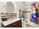 Charming bathroom featuring a tiled backsplash, modern vanity and tiled floors at 5717 Christchurch Ave, Las Vegas, NV 89110