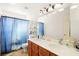 Bathroom with double sinks, a wooden vanity, and tiled floors at 5717 Christchurch Ave, Las Vegas, NV 89110