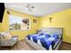 Bright bedroom with ceiling fan, large window and a comfortable armchair at 5717 Christchurch Ave, Las Vegas, NV 89110