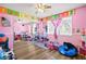 Spacious bedroom featuring an alphabet motif, large mirrors and laminated floors at 5717 Christchurch Ave, Las Vegas, NV 89110