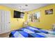 Bright bedroom with ceiling fan, large window, laminated floors and an armchair at 5717 Christchurch Ave, Las Vegas, NV 89110