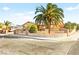 Attractive single-story house with mature palm trees and secure front gate at 5717 Christchurch Ave, Las Vegas, NV 89110