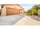 Spacious two-car garage featuring a long concrete driveway and mature landscaping at 5717 Christchurch Ave, Las Vegas, NV 89110